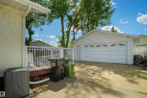Detached two-car garage with white vinyl siding and decorative garage door windows - 13524 26 Street, Edmonton, AB 