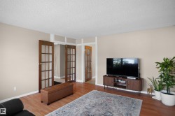 Warm wood-finish flooring complements the neutral wall tones - 