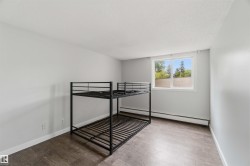 Room featuring light gray walls and wood-finish flooring - 