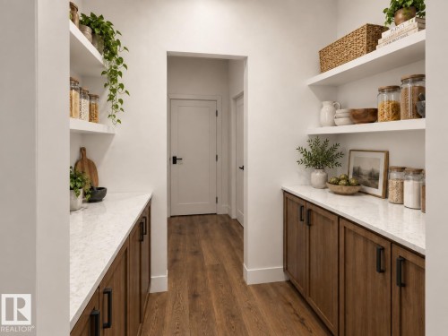 Walk-through pantry with wood-finish flooring, white floating shelves, white countertops, and wood-finish cabinetry with black hardware - 11 Brickyard View, Stony Plain, AB 