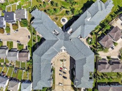 Multi-unit building with a complex roofline and ample surface parking - 