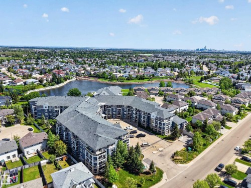 Modern multi-story building featuring multiple balconies and a dark shingled roof - 138 16035 132 Street, Edmonton, AB 