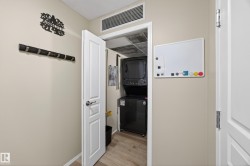 Compact laundry area featuring a stacked washer and dryer unit - 