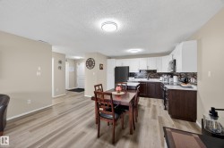 Open concept living area featuring wood-finish flooring, recessed lighting, and neutral wall tones - 