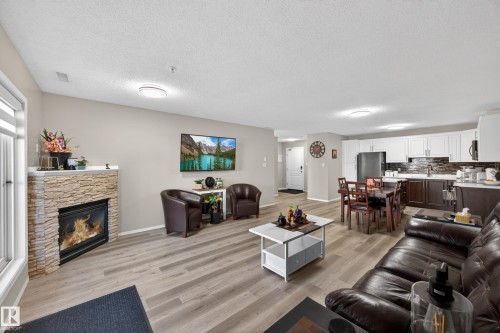 Open concept living area featuring wood-finish flooring - 138 16035 132 Street, Edmonton, AB 
