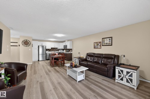 Open-concept main living area with wood-finish flooring - 138 16035 132 Street, Edmonton, AB 
