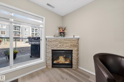 Corner fireplace featuring a stacked stone surround and white mantel - 