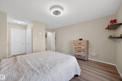 Neutral-toned room featuring light wood-finish flooring - 
