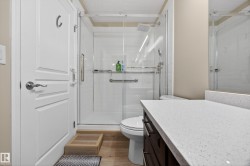 Glass-enclosed shower with subway tile surround and rain showerhead - 