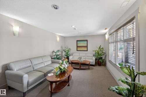 Spacious room featuring carpeting, recessed lighting, and wall sconces - 138 16035 132 Street, Edmonton, AB 
