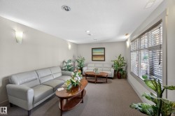 Spacious room featuring carpeting, recessed lighting, and wall sconces - 