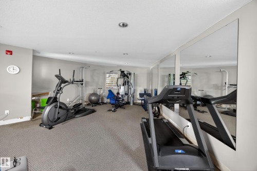 Carpeted fitness area with recessed lighting and full-height wall mirrors - 138 16035 132 Street, Edmonton, AB 
