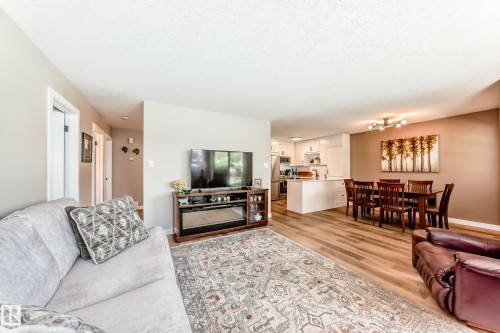 Open-concept living space featuring wood-finish flooring - 10822 11 Avenue, Edmonton, AB 