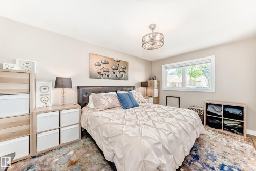 Room featuring a window with white trim, a ceiling-mounted light fixture, and light-toned walls - 10822 11 Avenue, Edmonton, AB 