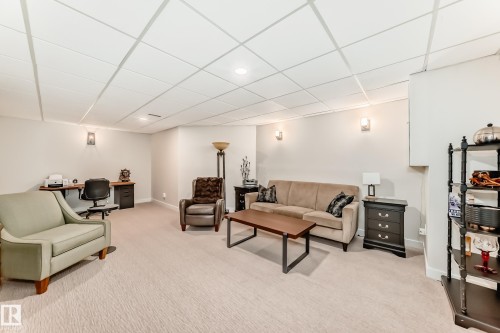 Carpeted lower level featuring recessed lighting and wall sconces - 10822 11 Avenue, Edmonton, AB 