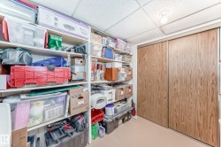 Storage area featuring built-in shelving and full-height sliding closet doors - 