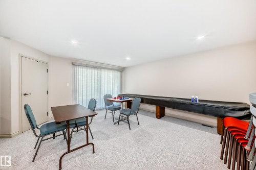 Spacious room with light-colored carpeting and recessed lighting - 10822 11 Avenue, Edmonton, AB 