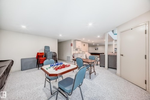 Spacious lower level featuring light gray carpeting, recessed ceiling lighting, and a neutral wall palette - 10822 11 Avenue, Edmonton, AB 