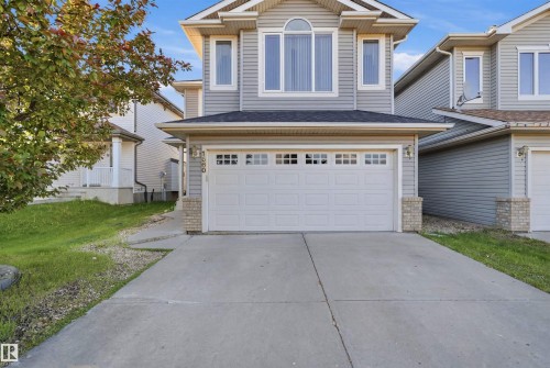 Two-story residence featuring light gray siding with white trim accents - 1560 37B Avenue, Edmonton, AB 