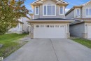 Two-story residence featuring light gray siding with white trim accents - 1560 37B Avenue, Edmonton, AB 