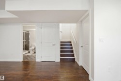 Wood-finish flooring throughout, featuring a bright white color palette - 