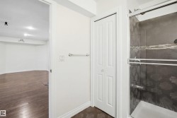 Compact three-panel bifold door, white walls, and wood-finish flooring - 