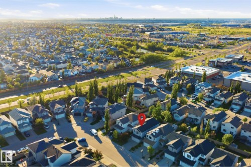 Residential street with established homes featuring front garages and mature landscaping - 1560 37B Avenue, Edmonton, AB 