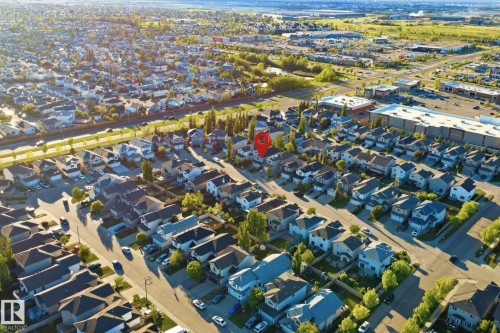 Aerial perspective showcasing a residential neighborhood with detached homes, mature trees, and street parking - 1560 37B Avenue, Edmonton, AB 