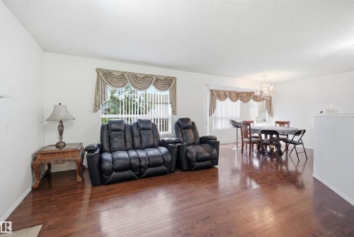 Open-concept living area featuring rich wood-finish flooring throughout - 1560 37B Avenue, Edmonton, AB 