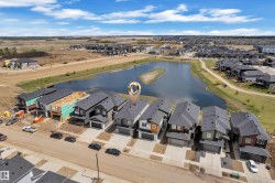 Aerial perspective showcasing a residential street with diverse modern home exteriors, several featuring attached garages - 