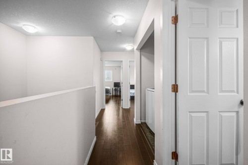 Upper-level hallway with wood-finish flooring - 4806 117 Ave, Edmonton, AB 