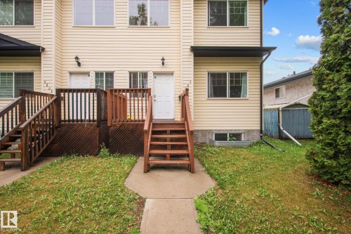 Cream-colored siding facade featuring multiple windows - 4806 117 Ave, Edmonton, AB 