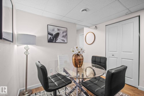 Neutral wall paint with drop ceiling, recessed lighting, and wood-finish flooring - 4806 117 Ave, Edmonton, AB 