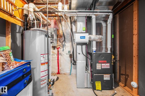 Mechanical room featuring a water heater, furnace, and visible ductwork - 4806 117 Ave, Edmonton, AB 