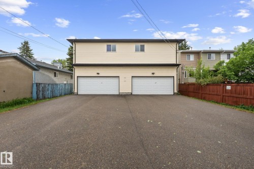 Two-story duplex with light-colored siding and a dark trim - 4806 117 Ave, Edmonton, AB 