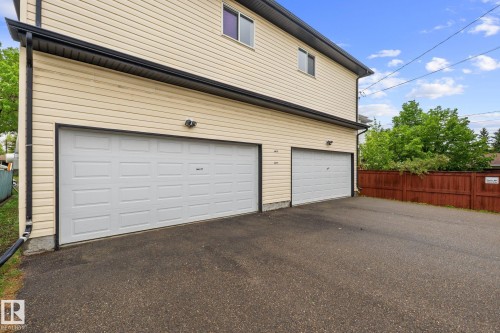 Cream horizontal siding exterior with black trim and gutters - 4806 117 Ave, Edmonton, AB 