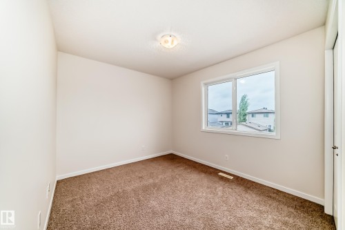 Neutral tone painted walls complement the brown carpeted flooring - 18103 77 Street, Edmonton, AB 