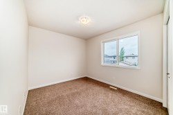 Neutral tone painted walls complement the brown carpeted flooring - 
