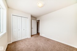 Carpeted room featuring a double bi-fold closet, a single window, and a flush-mount ceiling light fixture - 