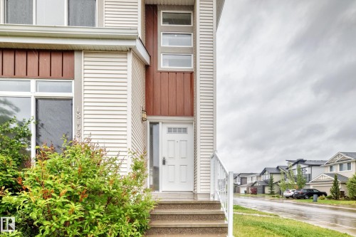 Multi-level facade featuring horizontal siding and vertical wood-look accents - 18103 77 Street, Edmonton, AB 