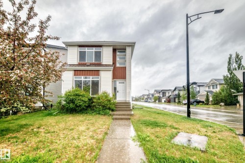 Two-story home with white siding and brown accent panels - 18103 77 Street, Edmonton, AB 