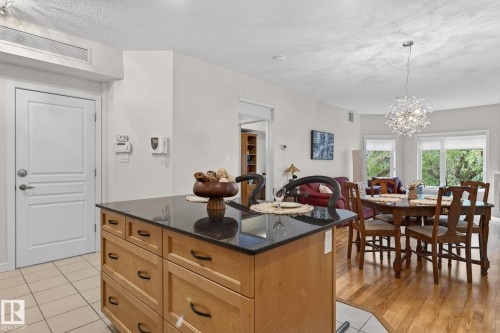 Kitchen island featuring a dark countertop and light wood-finish cabinetry - 208 5 Gate Avenue, St. Albert, AB 