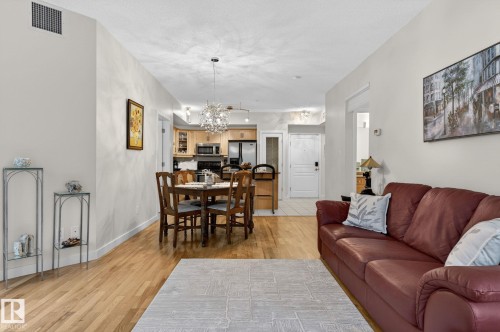 Open-concept living area featuring wood-finish flooring and neutral wall tones - 208 5 Gate Avenue, St. Albert, AB 