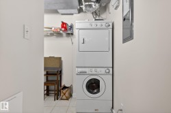 Dedicated laundry area featuring a stackable washer and dryer unit, overhead wire shelving, and tiled flooring - 