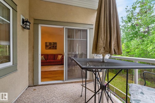 Outdoor balcony with textured flooring and white railing - 208 5 Gate Avenue, St. Albert, AB 