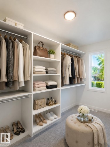 Custom-built closet system featuring extensive shelving, multiple hanging rods, and light gray carpeting - 3150 Magpie Way, Edmonton, AB 