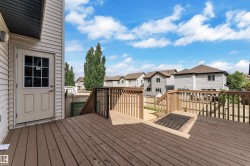 Spacious wood-finish deck with integrated railing system - 