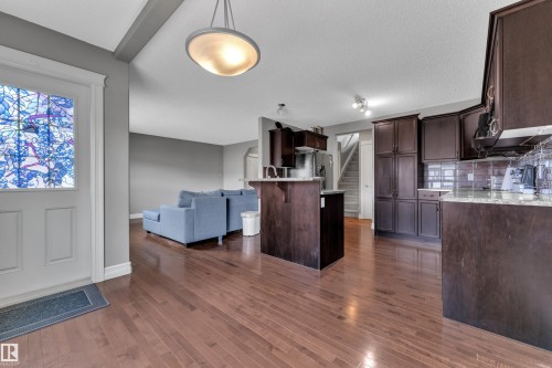Expansive wood-finish flooring throughout the main level - 6116 11 Avenue, Edmonton, AB 