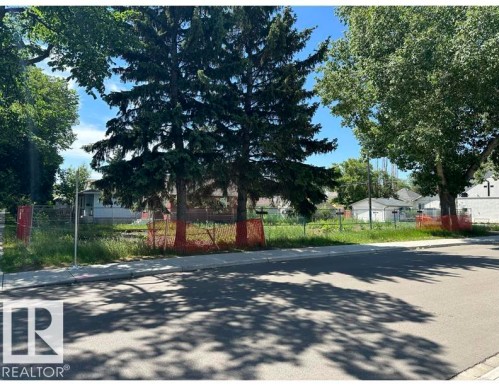 Vacant land parcel featuring mature evergreen trees and established deciduous trees - 12072 95 Street, Edmonton, AB 