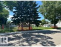 Vacant land parcel featuring mature evergreen trees and established deciduous trees - 12072 95 Street, Edmonton, AB 